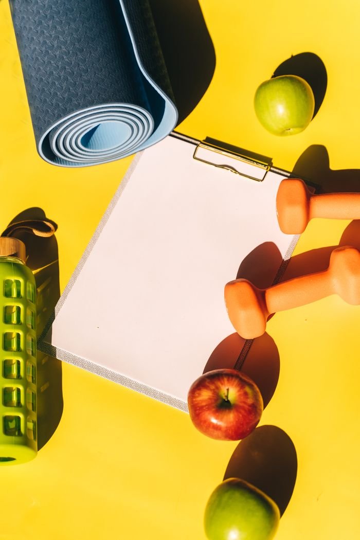 Mastering the First Impression: Your intriguing post title goes here A flat lay of fitness equipment, fruits, and a clipboard on a vibrant yellow background.